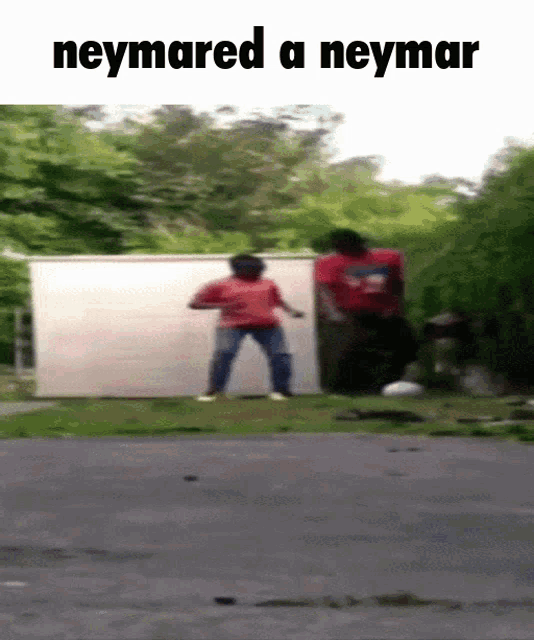 a man in a red shirt is standing in front of a white wall with the words " neymared a neymar " below him