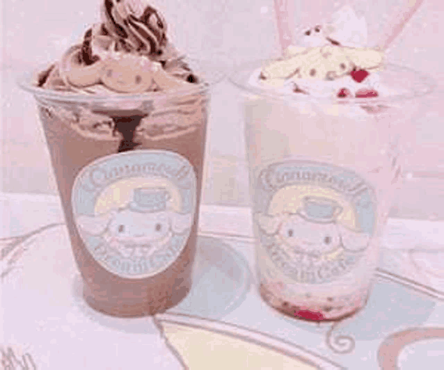 two cups of cinnamoroll drinks are on a table .