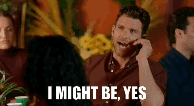 a man talking on a cell phone with the words i might be yes
