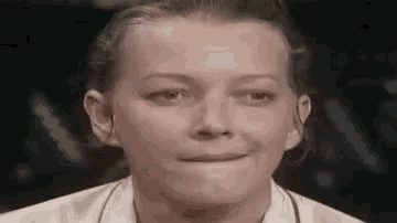 a close up of a woman making a funny face with her mouth open .