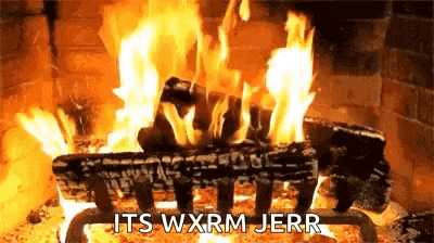 a fire is burning in a fireplace with the words `` it 's wxrm jerr '' written on the screen .