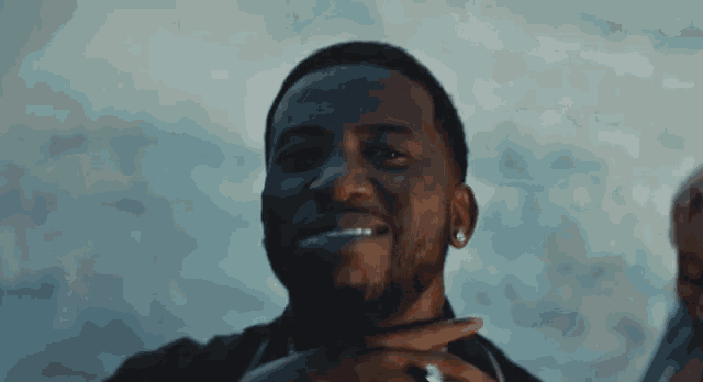 a close up of a man 's face with his hand on his chin