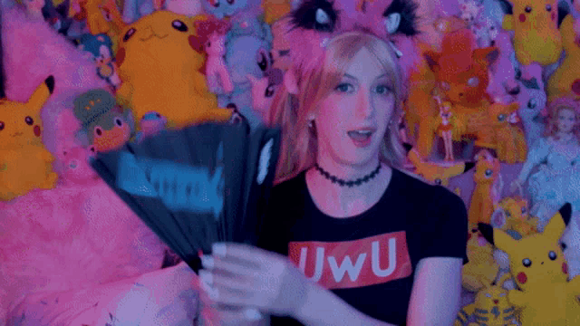a woman holding a fan that says " i love th " on it