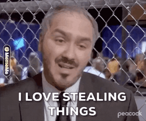 a man in a suit and tie is behind a chain link fence .