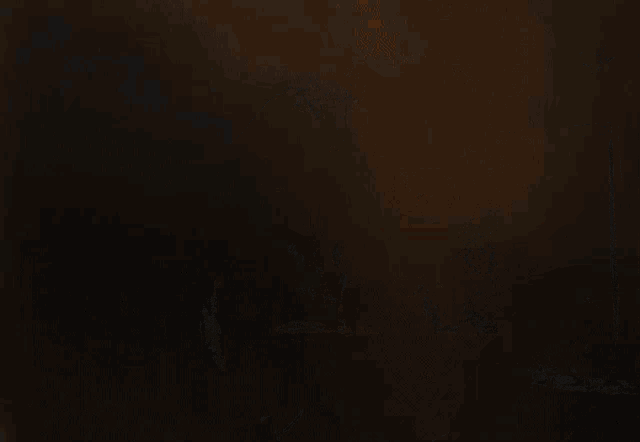 a man in a white shirt is standing in front of a house at night
