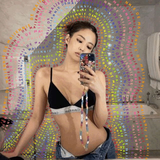 a woman in a calvin klein bra takes a picture of herself in a mirror