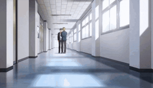 a long hallway with a lot of windows and people walking