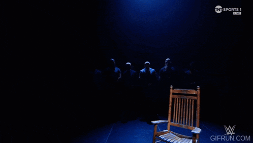 a rocking chair in a dark room with tnt sports 1 on the bottom right