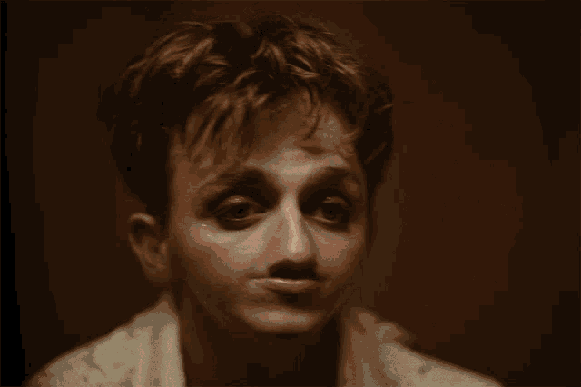 a close up of a person 's face with their eyes closed