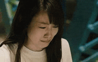 a close up of a woman 's face with tears running down her face .