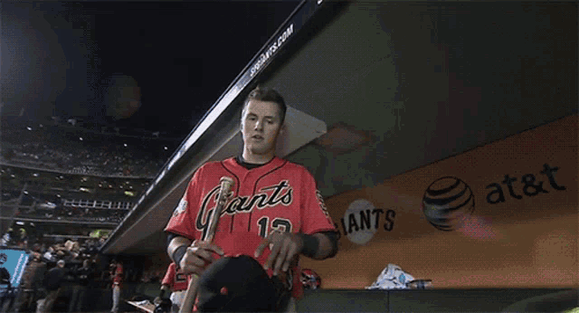 a baseball player wearing a red jersey with the number 2 on it
