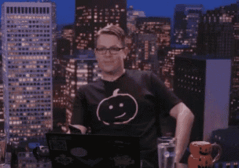 a man wearing a black t-shirt with a pumpkin on it