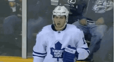 a hockey player in a toronto maple leafs uniform
