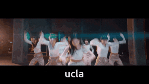 a group of women are dancing with the word ucla in the corner