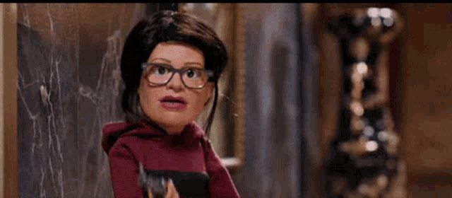 a cartoon doll with glasses is holding a bird in her hand and looking at it .