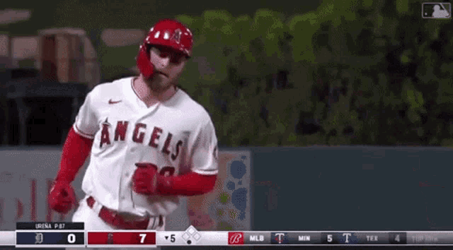 a baseball player in a white jersey with the letter a on it