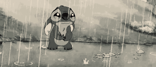 a black and white cartoon of stitch standing in the rain with a sad look on his face