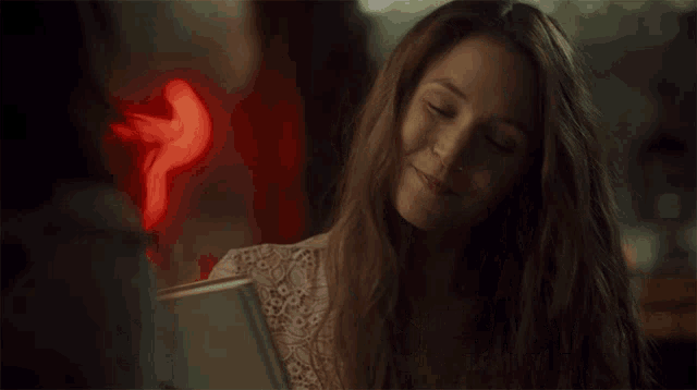 a woman is smiling and holding a book with the words she 's my best baby below her