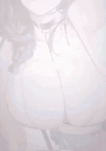 a close up of a woman 's breasts in a white top