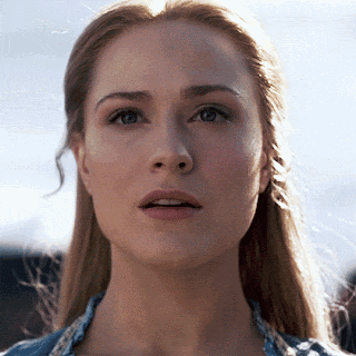 a close up of a woman 's face with a serious expression