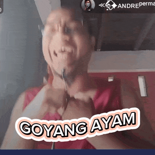 a man is holding a pair of scissors around his neck and a sticker that says goyang ayam on it