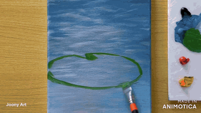 a painting of a circle is being painted by joony art