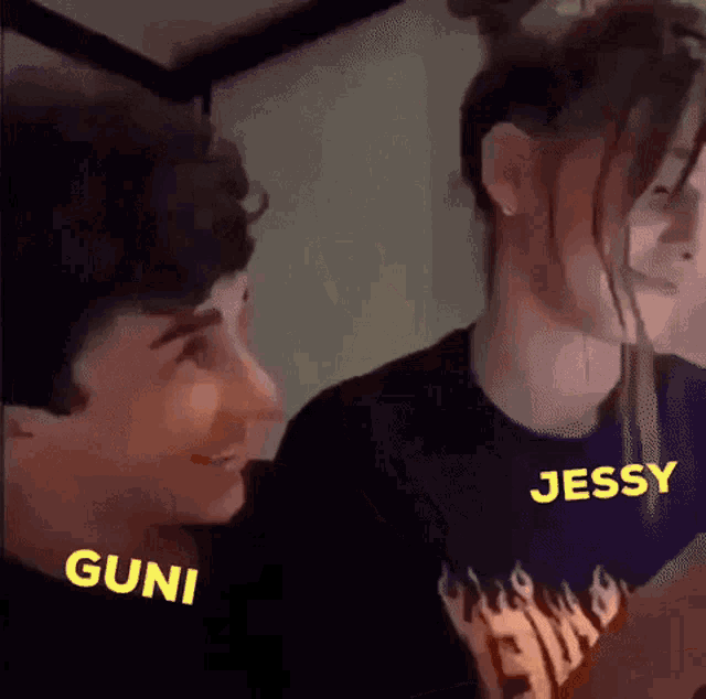 a boy and a girl are standing next to each other and the girl is wearing a shirt that says jessy .