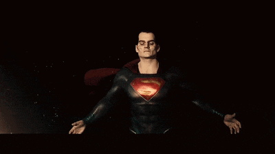 a close up of a man in a superman costume with his eyes glowing