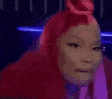 a woman with pink hair is sitting in the back seat of a car looking out the window .