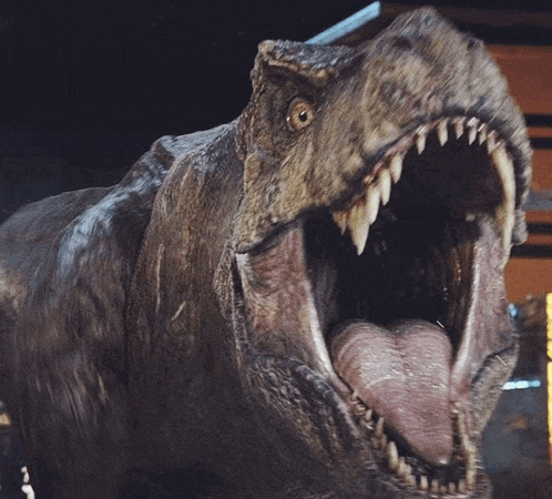 a close up of a dinosaur 's mouth with its tongue hanging out
