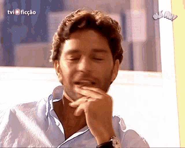 a man is laughing in front of a tv screen that says tvi fiction