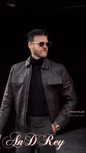 a man wearing sunglasses and a black jacket with the name andrey on the bottom right