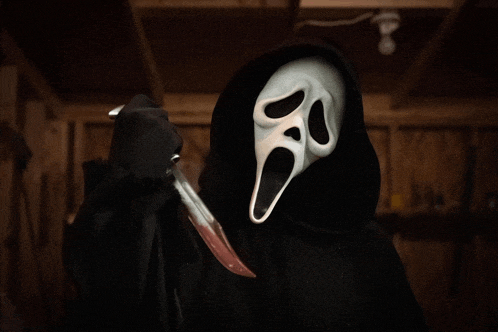 a person with a scream mask holding a bloody knife
