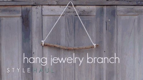 a woman hangs necklaces on a wooden branch with the words decorate with your favorite necklaces