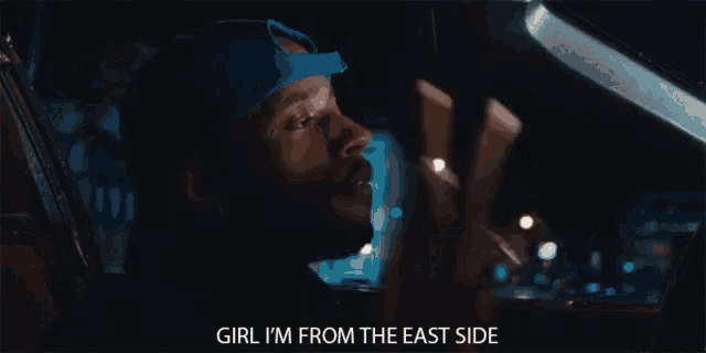 a man in a car with the words girl i 'm from the east side next to him