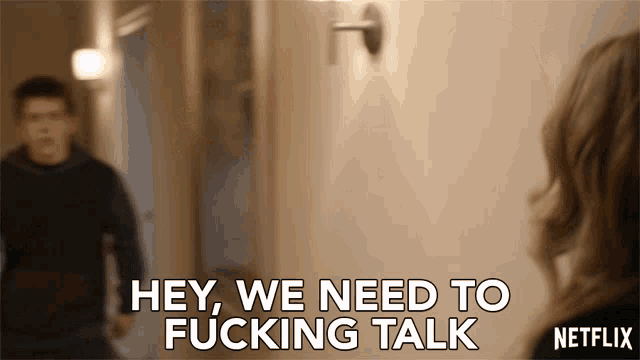 a netflix ad shows a man and woman in a hallway and says " hey we need to fucking talk "