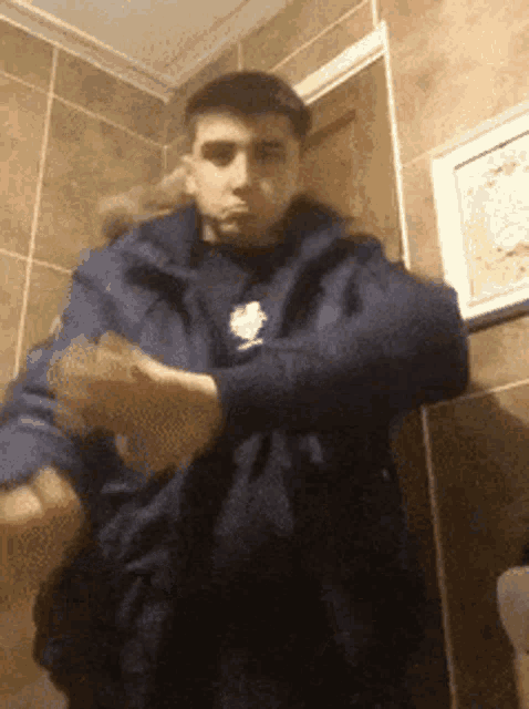 a man in a blue jacket with the word reebok on it
