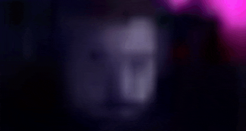 a blurry picture of a person 's face in the dark