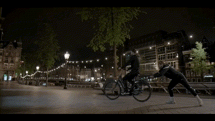 a man riding a bike is being pulled by another man