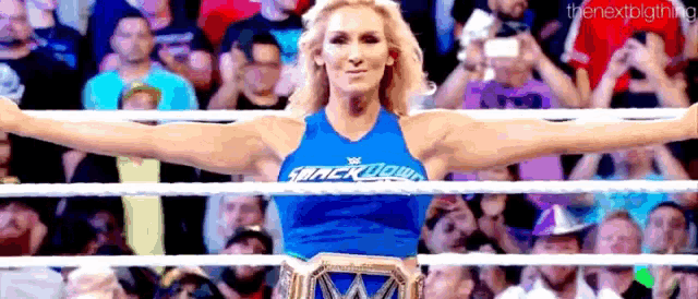 a female wrestler in a blue shirt with the word smackdown on it