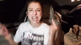 a woman wearing a hollywood t-shirt giving the middle finger