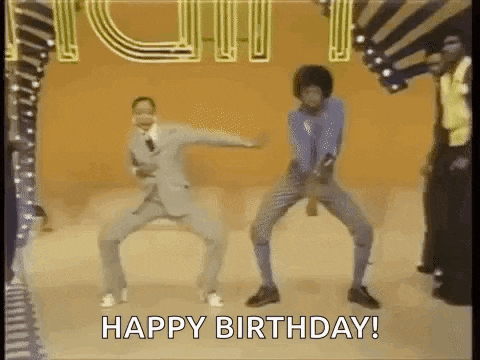 two men are dancing on a stage with the words `` happy birthday '' written below them .