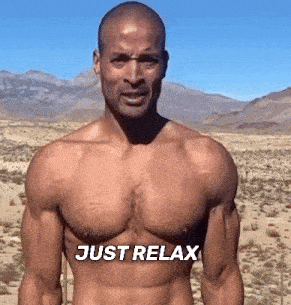 a shirtless man is standing in the desert with the words just relax written on his chest
