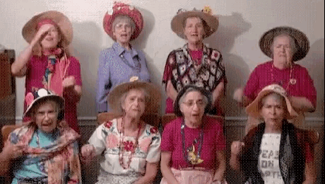 a group of elderly women wearing cowboy hats and a shirt that says eat or die