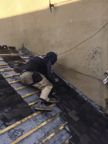 a man is working on a roof with a roof covering that says flex on it