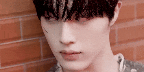 a close up of a person 's face with a scar on his face .