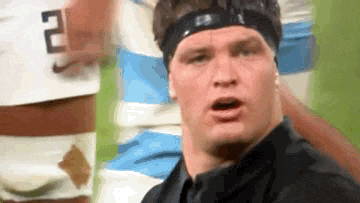 a man wearing a headband with a number 2 on it