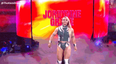 a female wrestler named jordynne grace is walking into a ring