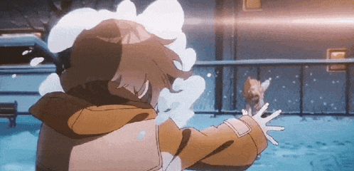a person in a brown jacket is throwing snow at a cat