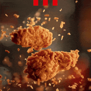 two pieces of fried chicken falling in the air